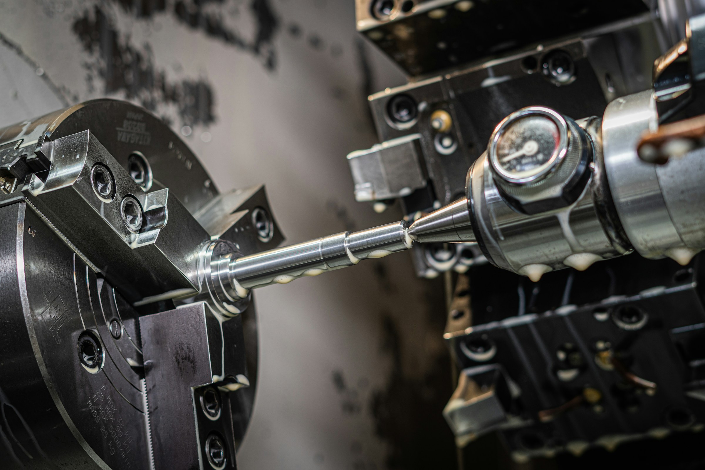A shaft being machined on a CNC lathe.