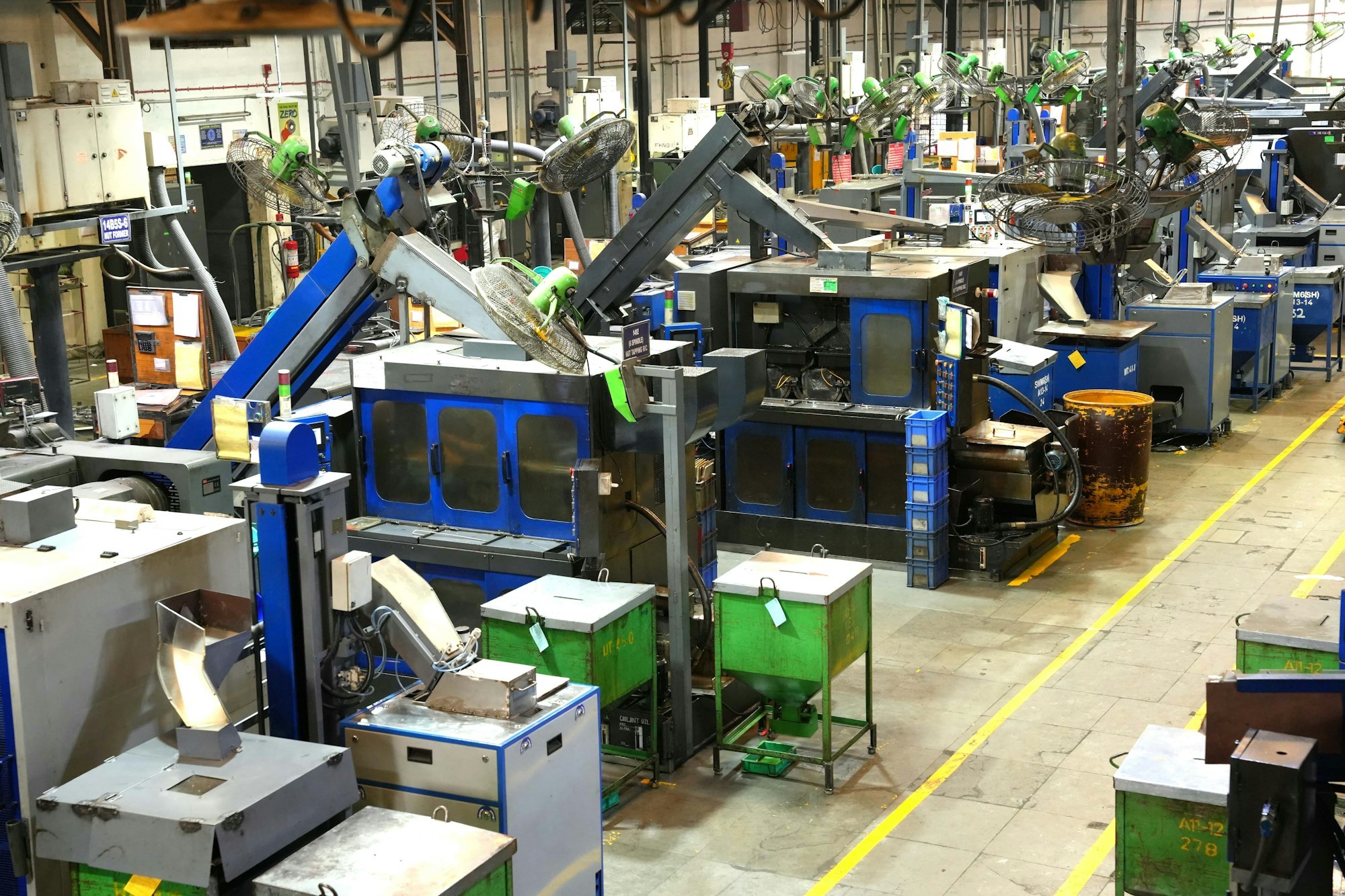Machinery and marked paths on a working factory floor.