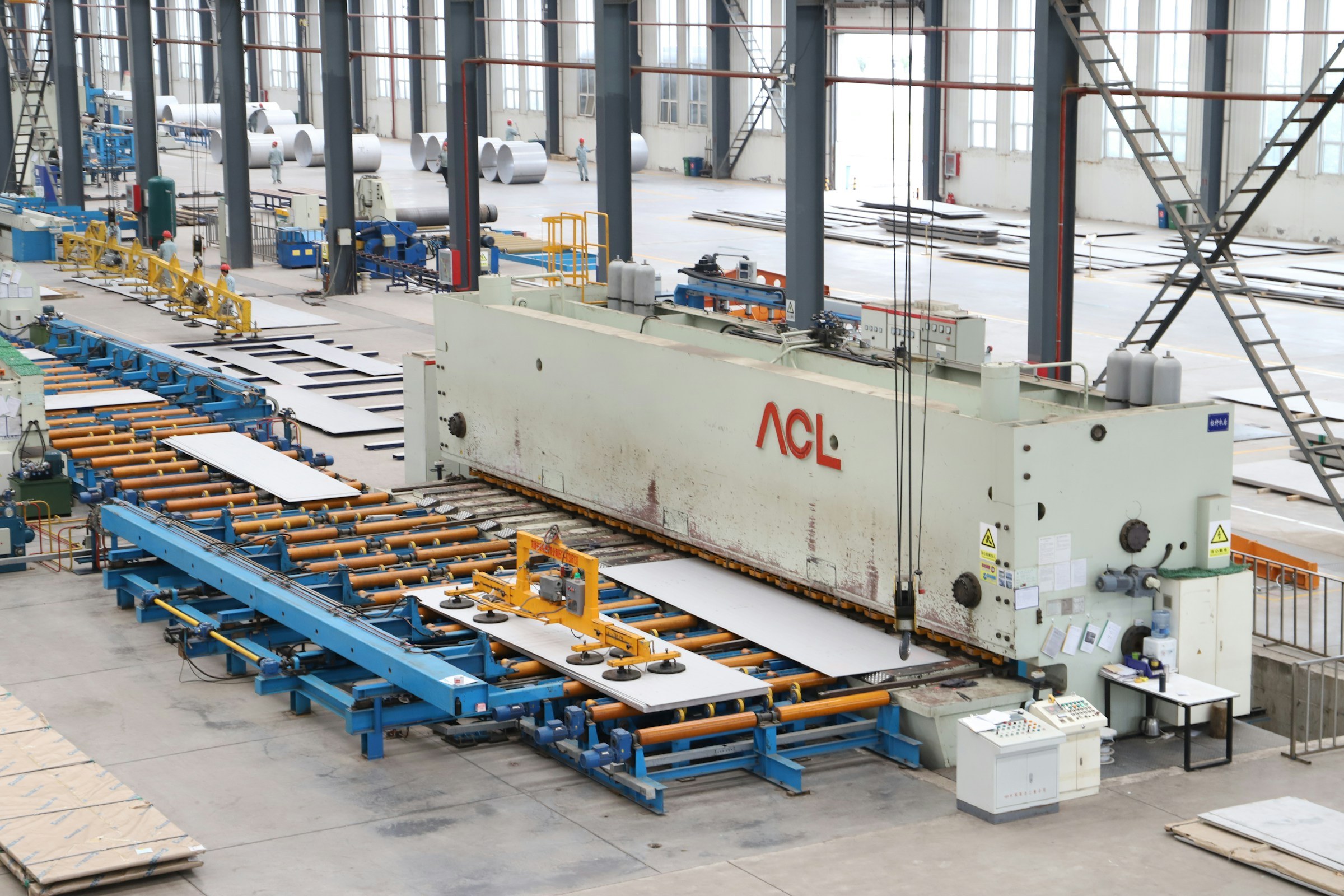 A large metal fabrication line on an industrial factory floor.