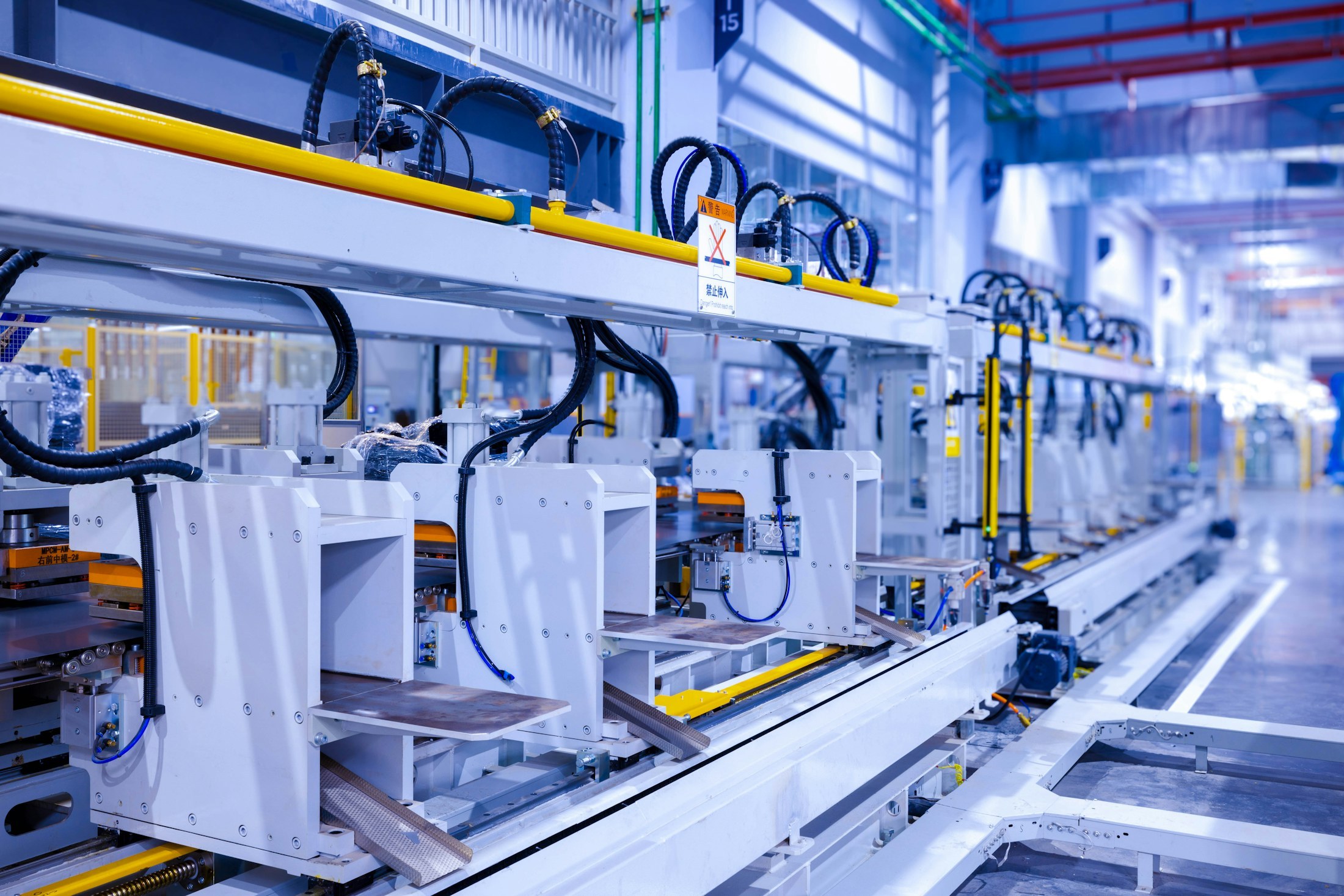A row of production machines inside a manufacturing plant.