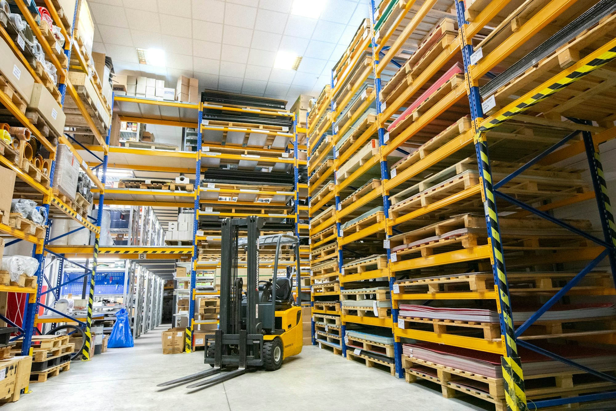 Pallet racks and a forklift in a parts warehouse.